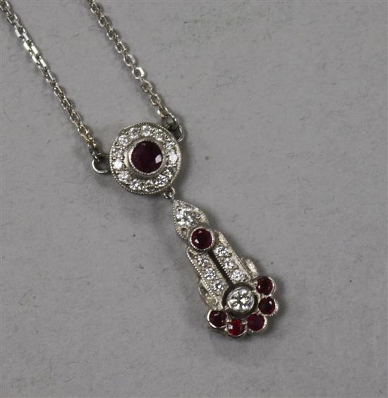 An 18ct white gold, ruby and diamond cluster drop pendant necklace, pendant 27mm.